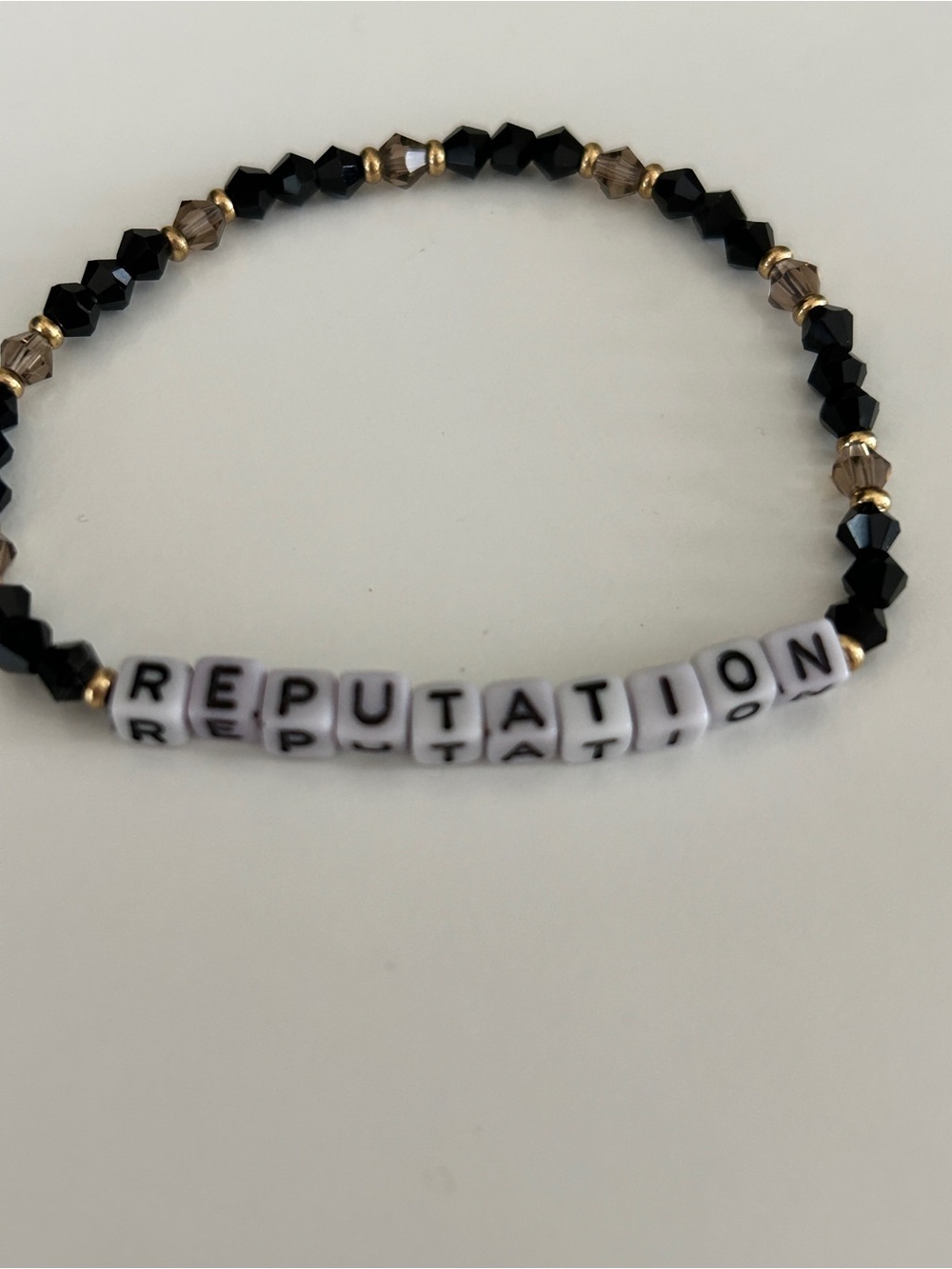 Reputation Beaded Stretch Bracelet - Black and Gold Lettered Design